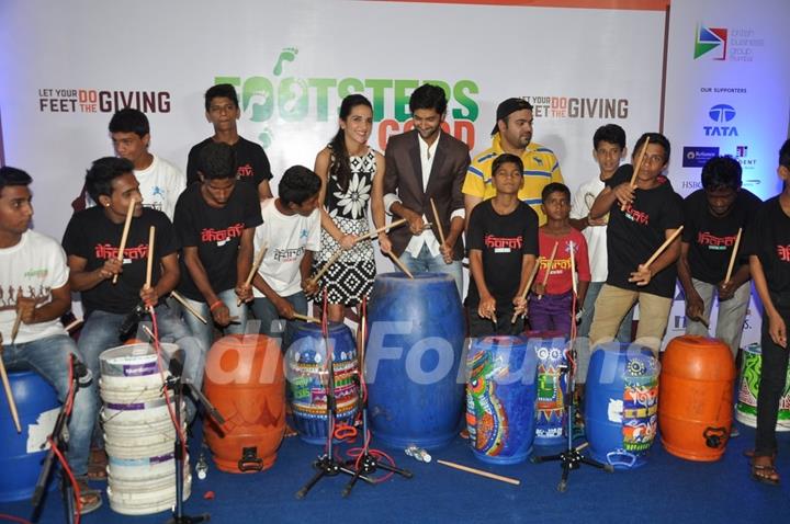 Purab Kohli and Tara Sharma playing the drum with kids at Footsteps 4 Good Ngo Event