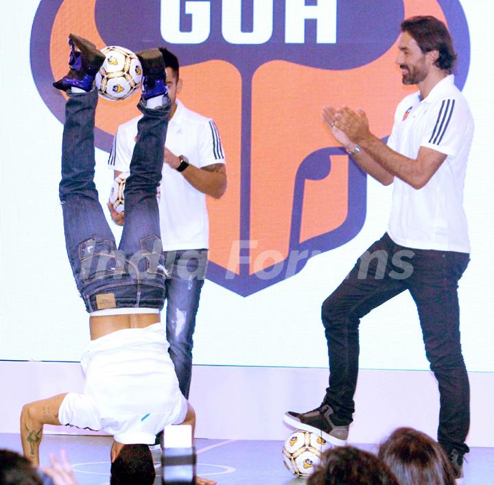 Varun Dhawan does a head stand with a football at the FC Goa Official Jersey Launch