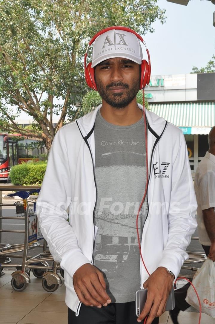 Dhanush poses for the media at Airport