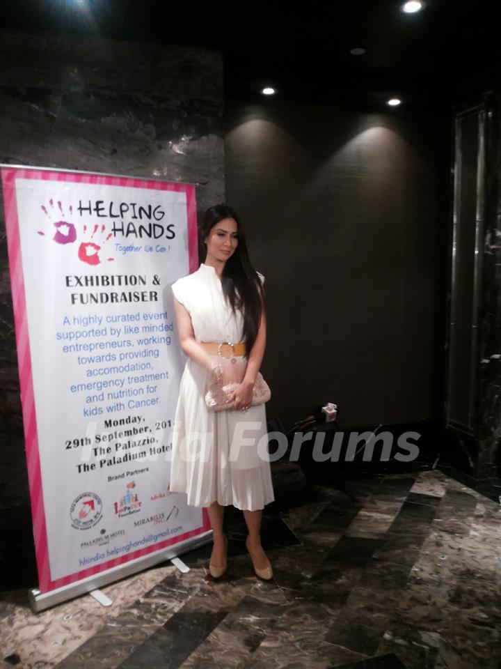 Kim Sharma poses for the media at the Helping Hands Exhibition