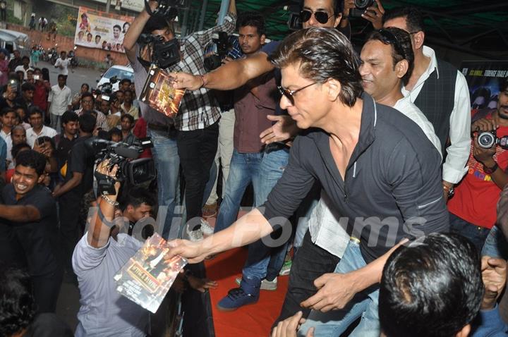 Shahrukh Khan distributes the Happy New Year DVDs among his Fans at the theatre