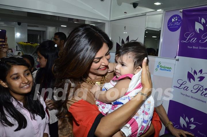 Sushmita Sen plays with a kid at Dr. Trasi's Clinic Launch