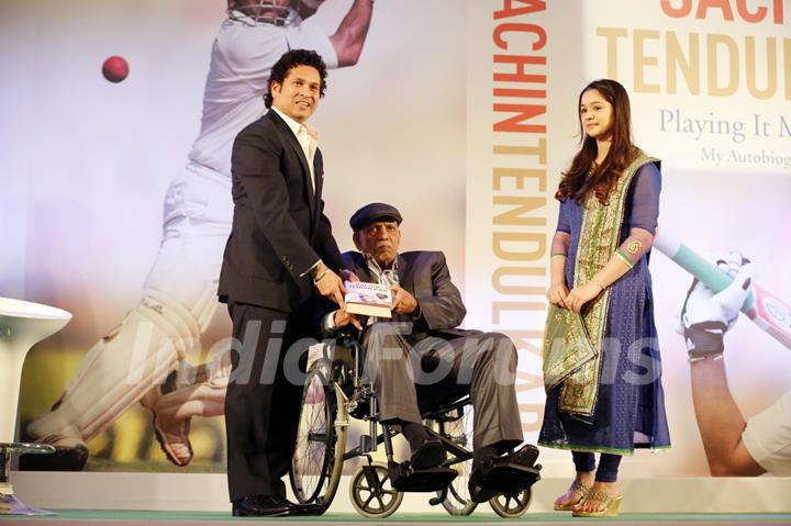 Sachin Tendulkar presenting copy to his first coach and guru Ramakant Achrekar