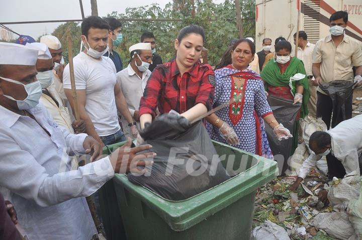 Tammanah unloads the garbage in a bin at a Cleanliness Drive