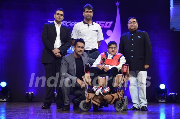 MS Dhoni poses with the special child at Positive Health Awards