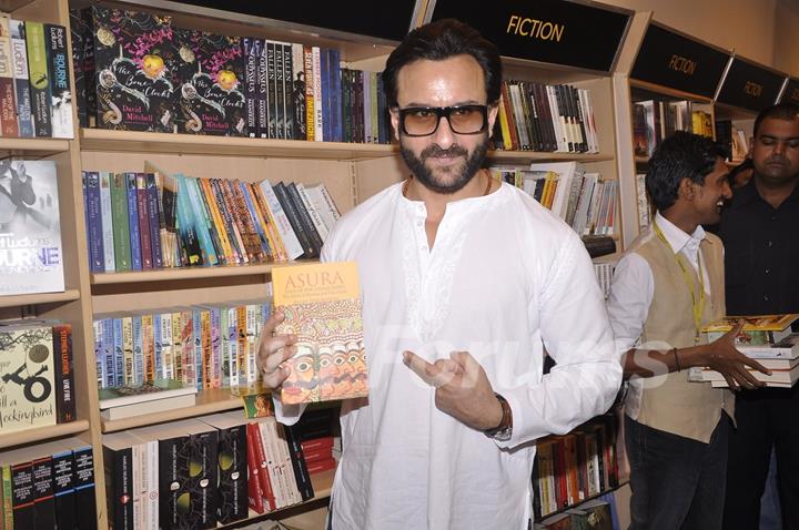 Saif Ali Khan poses with a book at the Promotions of Happy Ending