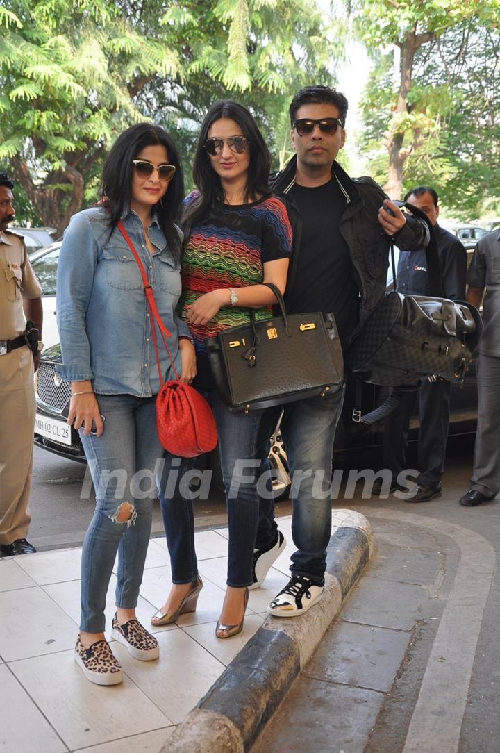 Karan Johar poses with friends at airport while leaving for Arpita Khan's Wedding