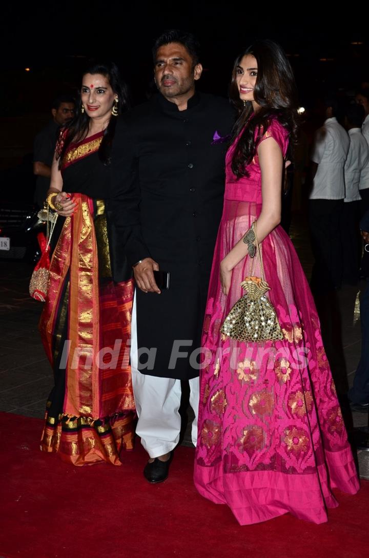 Suniel Shetty poses with wife Mana Shetty and daughter Athiya Shetty at Arpita's Wedding Reception