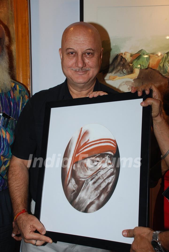 Anupam Kher poses with the potrait of Mother Teresa at the Inauguration of India Art Festival