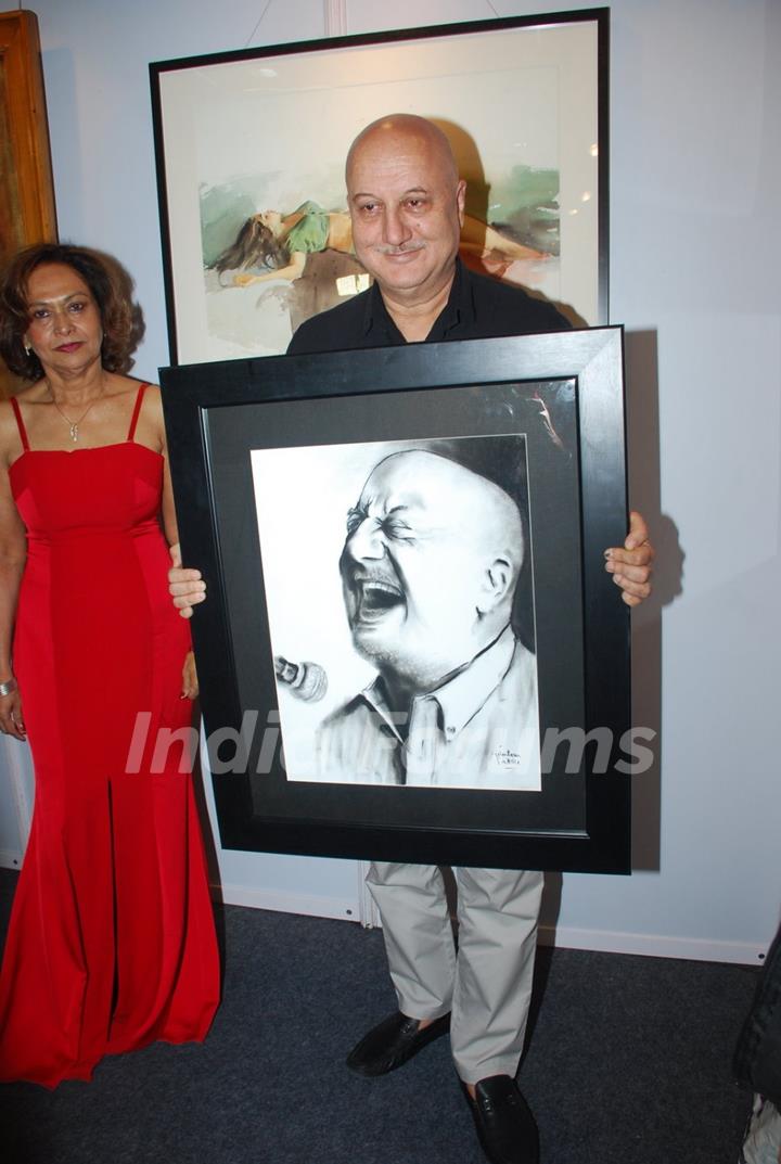 Anupam Kher poses with his potrait at the Inauguration of India Art Festival