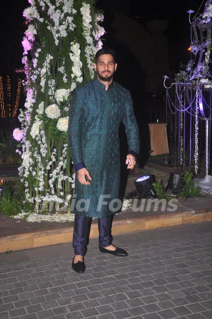 Sidharth Malhotra poses for the media at the Sangeet Ceremony of Riddhi Malhotra and Tejas Talwalkar