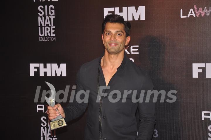 Karan Singh Grover poses with his award at FHM Bachelor of the Year Bash