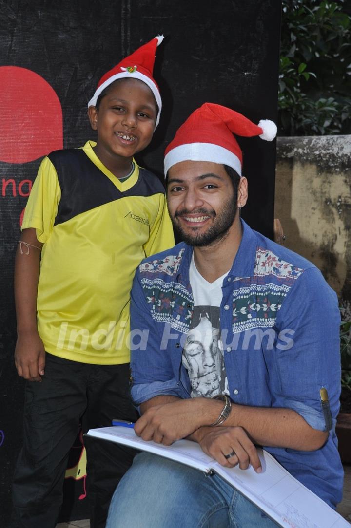 Ali Fazal poses with a Ngo Kid at the Christmas Celebrations