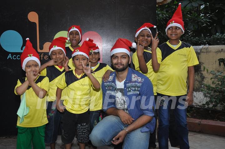 Ali Fazal poses for the media with Ngo Kids at the Christmas Celebrations