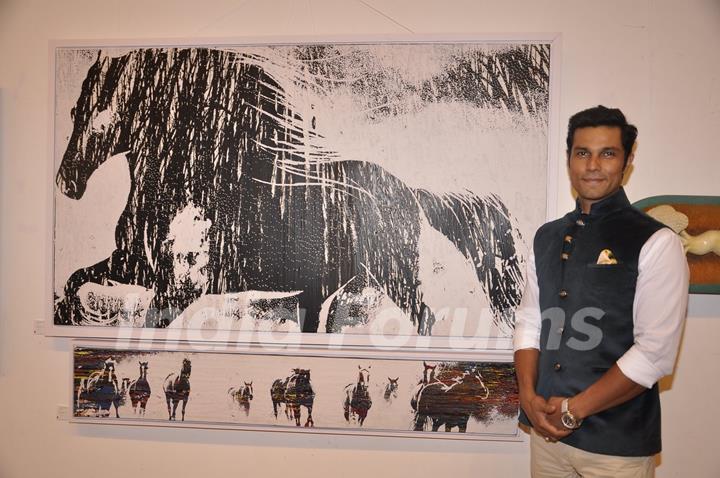 Randeep Hooda poses for the media at an Art Exhibition