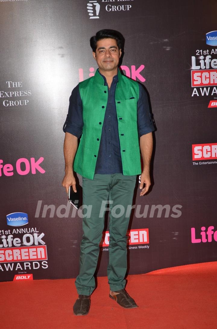 Sushant Singh poses for the media at 21st Annual Life OK Screen Awards Red Carpet
