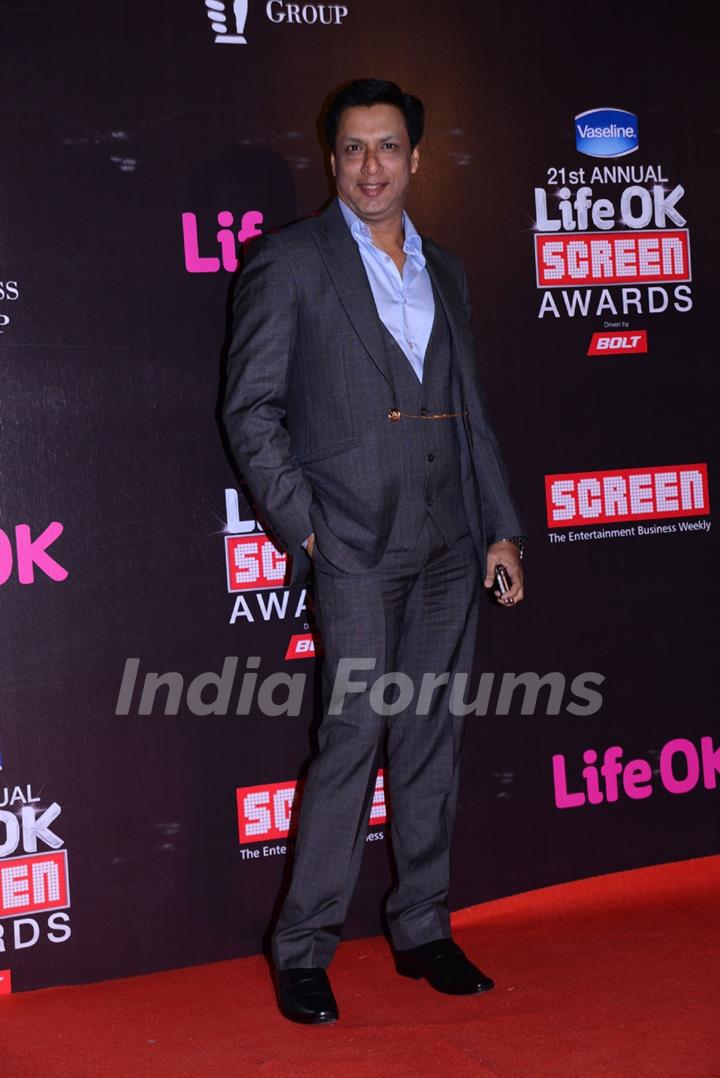 Madhur Bhandarkar poses for the media at 21st Annual Life OK Screen Awards Red Carpet
