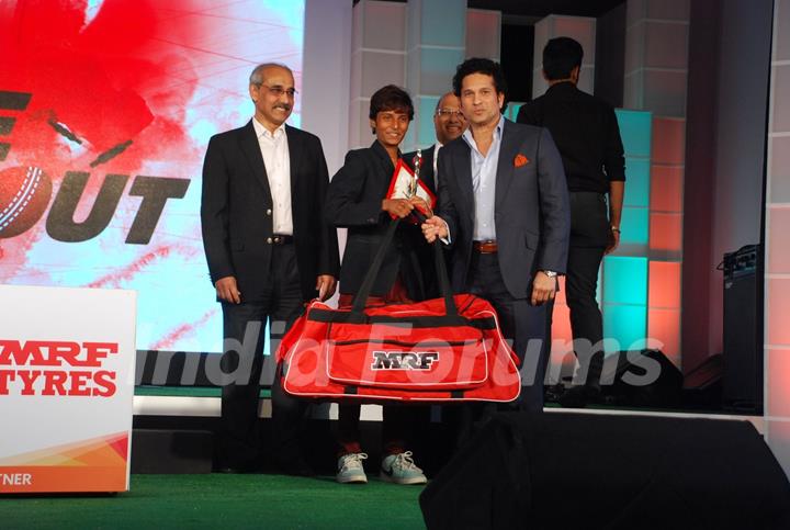 Sachin Tendulkar felicitates a boy at MRF Promotions