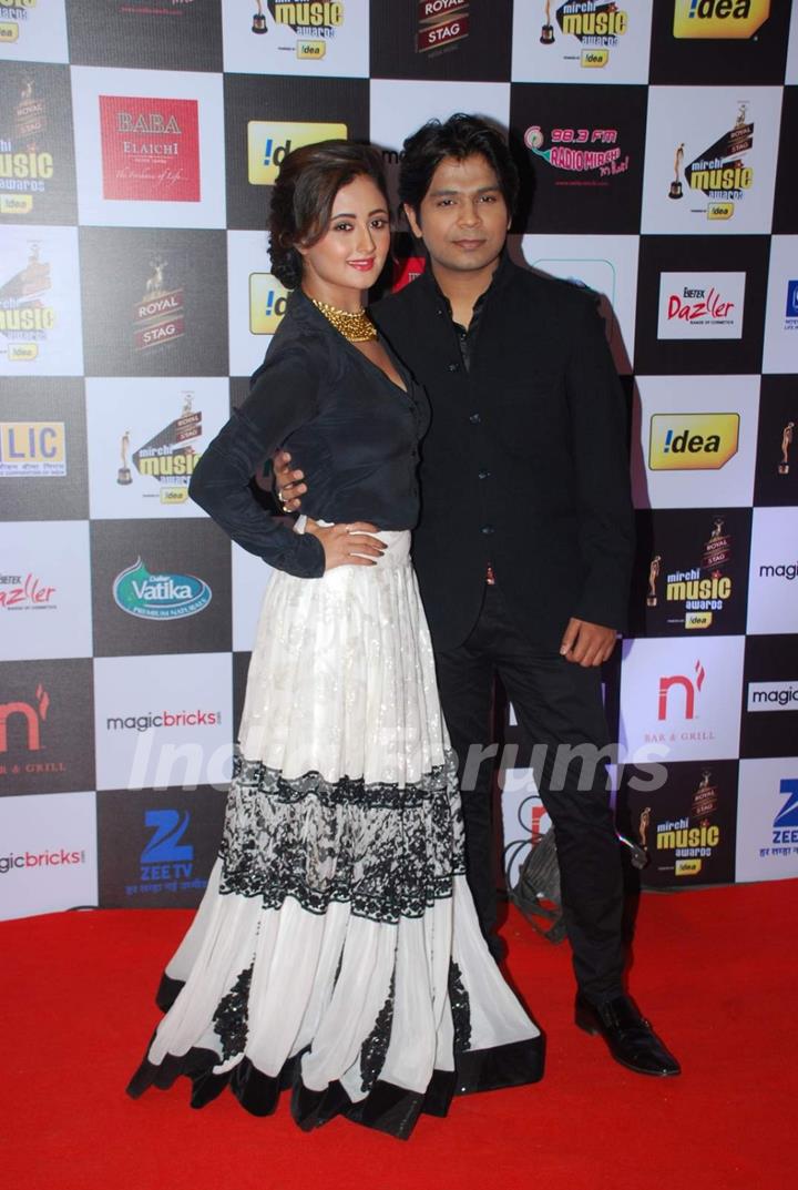 Rashmi Desai and Ankit Tiwari pose for the media at Radio Mirchi Awards