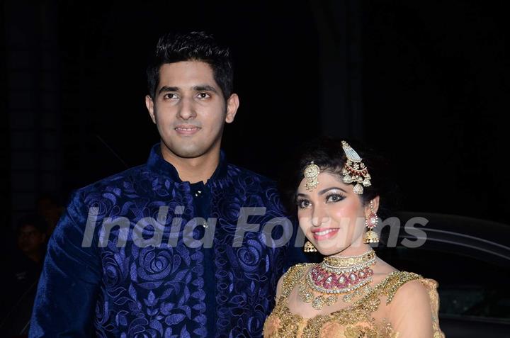 Tulsi Kumar and Hitesh Rahlan pose for the media at their Wedding Reception