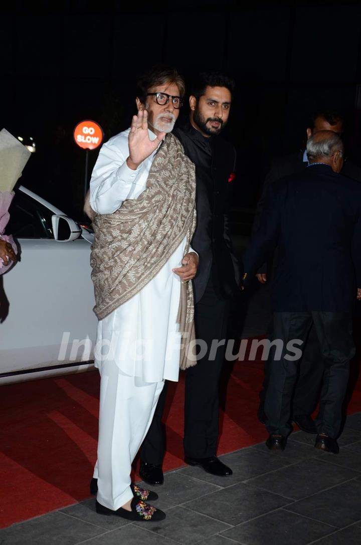 Amitabh Bachchan and Abhishek Bachchan pose for the media at Tulsi Kumar's Wedding Reception