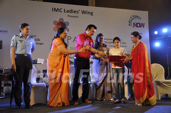 Anu Malik presents an award to a girl at IMC Ladies Wing Event