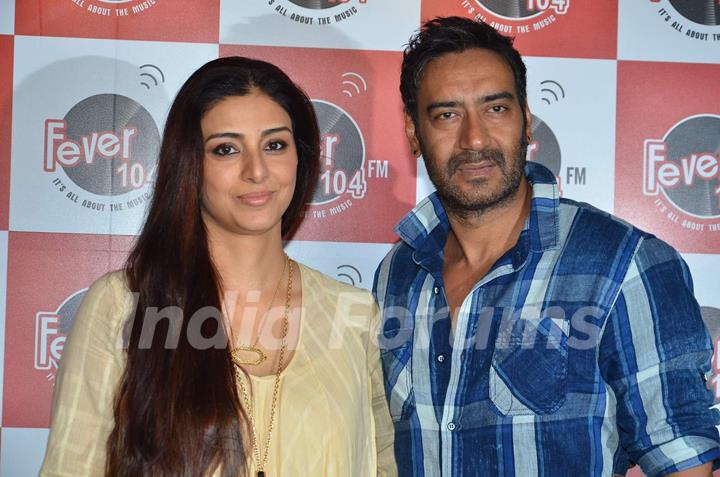 Ajay Devgn and Tabu pose for the media at the Promotions of Drishyam on Fever FM