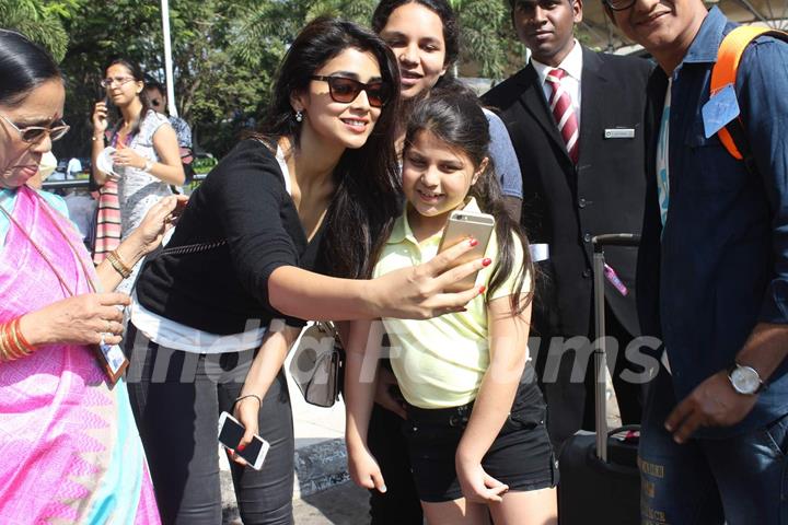 Shriya Saran was snapped clicking a selfie with a fan at Airport