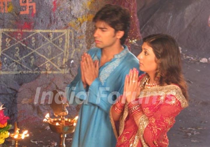 Sumit and Kumkum praying to God