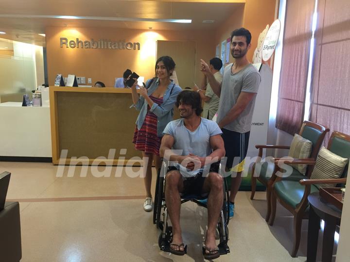 Picture of Vidyut Jamwal who is seen sitting on a wheelchair accompanied by his co-stars.
