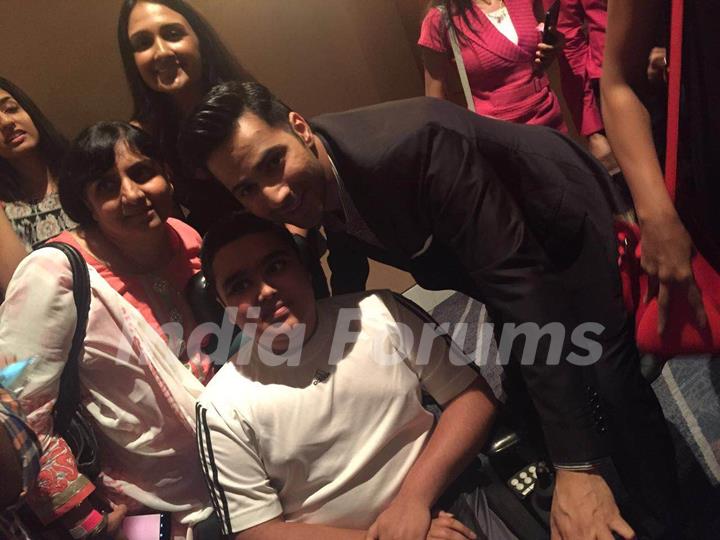 Varun Dhawan takes a picture with a fan