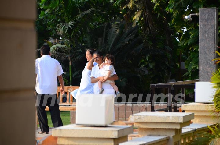 Taimur Ali Khan walking by the poolside