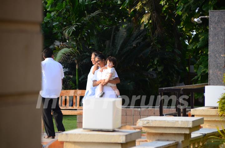 Taimur Ali Khan walking by the poolside