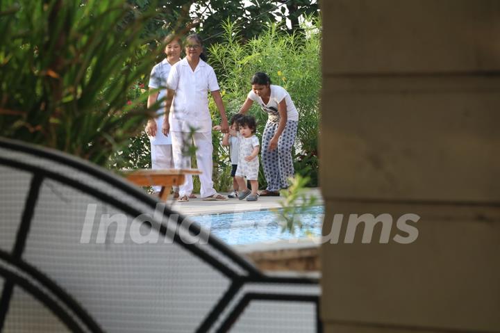 Taimur Ali Khan walking by the poolside