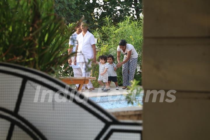 Taimur Ali Khan walking by the poolside