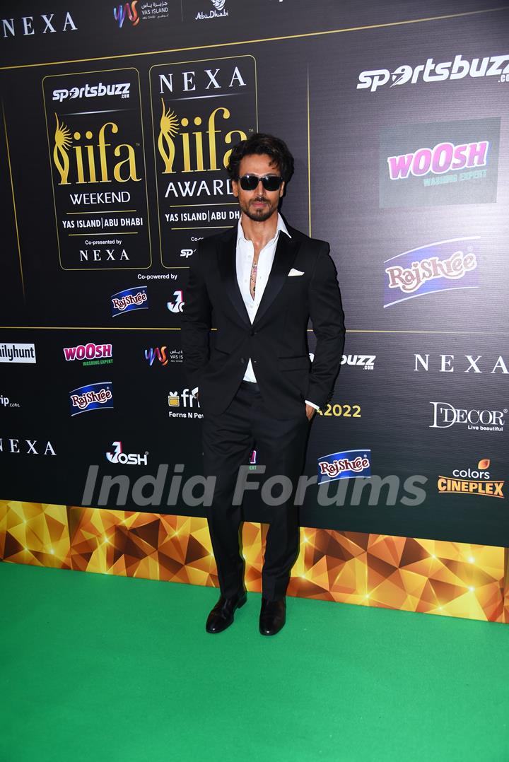 Tiger Shroff poses to paparazzi at green carpet of IIFA awards 2022 in Abu Dhabi