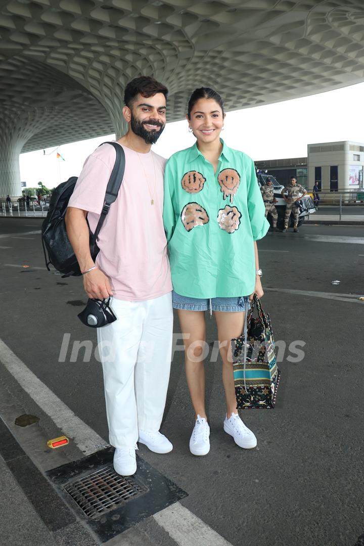 Anushka Sharma poses with Virat Kohli to the paparazzi at the Mumbai airport 