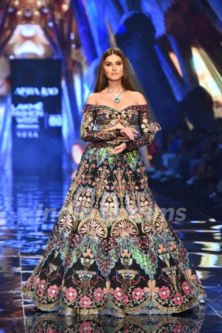 Tara Sutaria looked alluring in a a floral multicolored lehenga as she walked the ramp at the Lakme Fashion Week