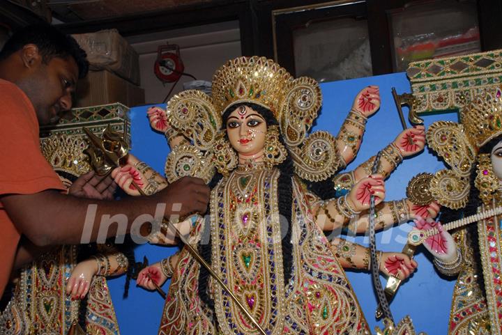 An Artist of Kumartuli finishing touch at a Durga idol made by Shola (Pith) for overseas country (Canada) in Kolkata on Wednesday 12th Aug 09