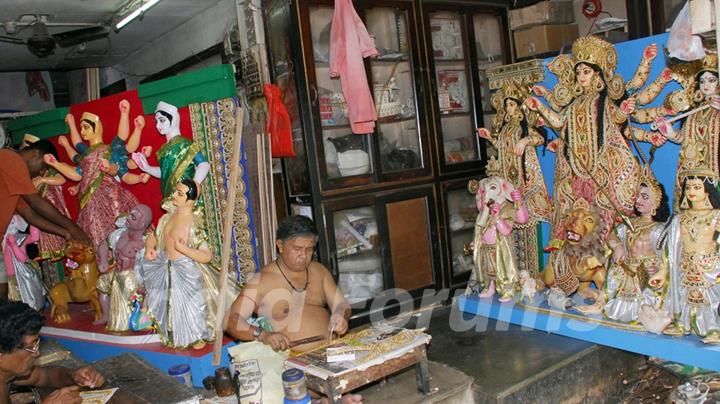 An Artist of Kumartuli finishing touch at a Durga idol made by Shola (Pith) for Overseas country (England left and Canada) in Kolkata on Wednesday 12th Aug 09