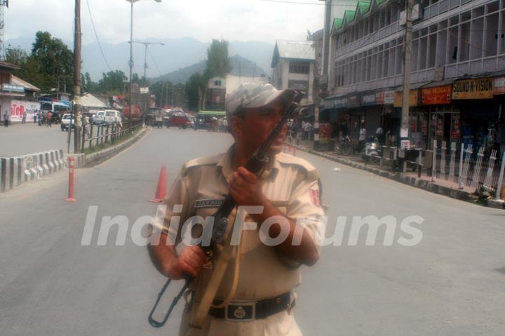 An armed security force personnel near the site of the gun fight with two militants in Srinagar