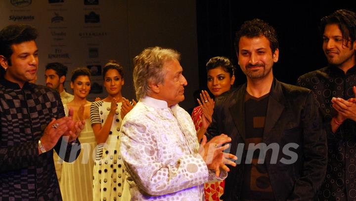 Ustad Amjad Ali Khan and his son Aman Ali Bangash and Ayan Ali Bangas showcases a design by Zubzir Kirmani on the catwalk during the Kolkata Fashion Week in Kolkata on 9th Sept 2009