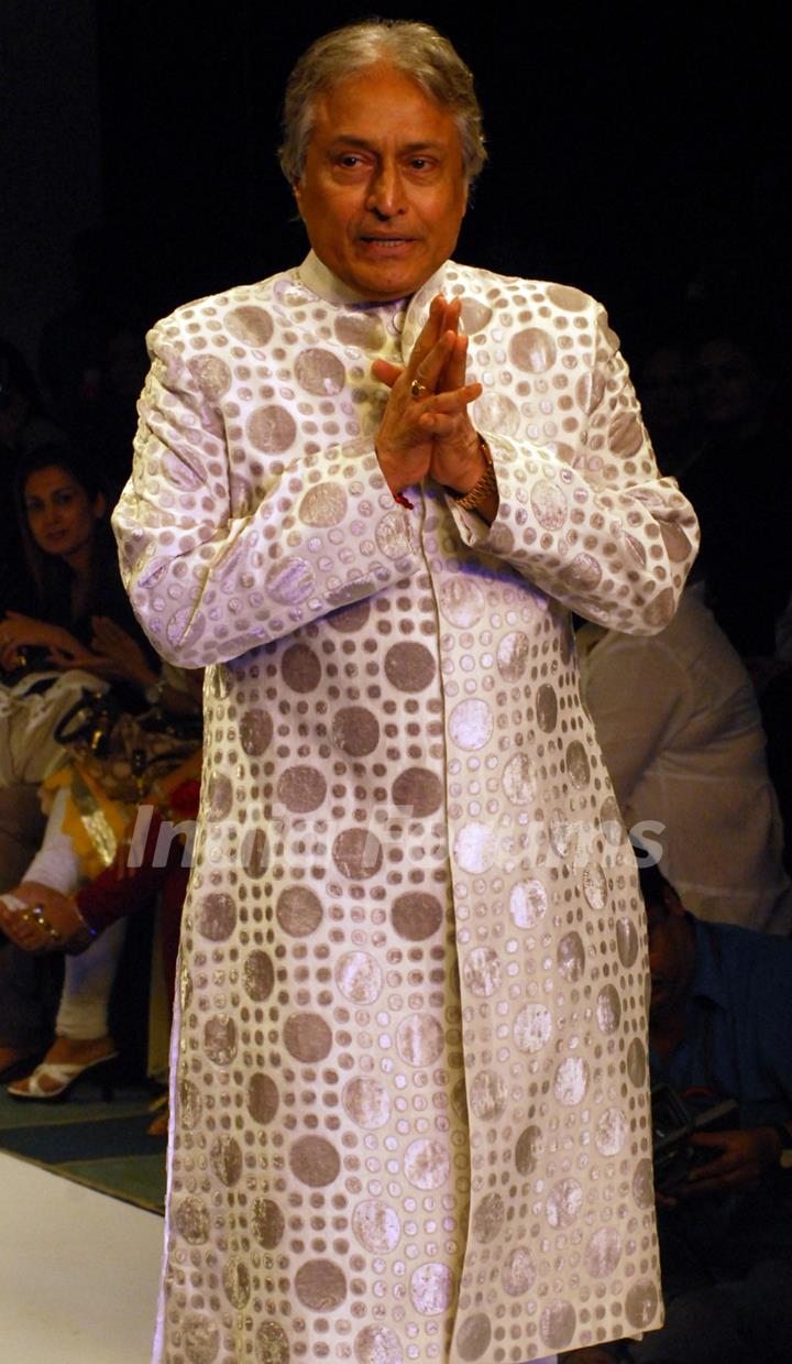 Ustad Amjad Ali Khan showcases a design by Zubzir Kirmani on the catwalk during the Kolkata Fashion Week in Kolkata on 9th Sept 2009