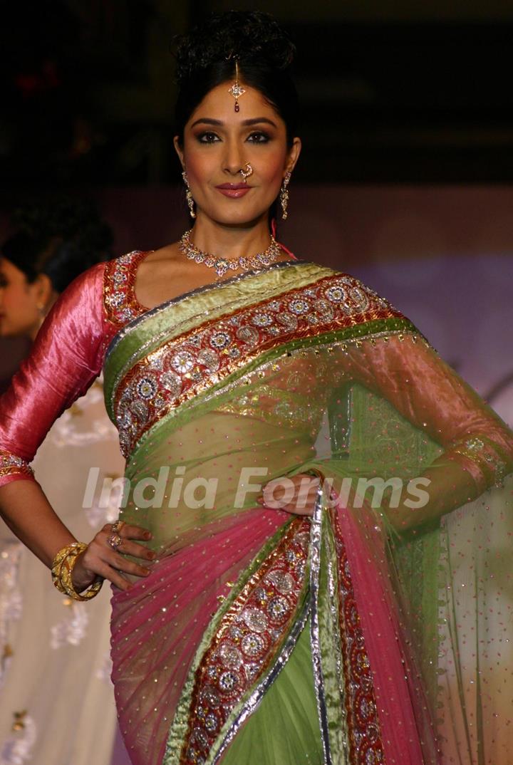 A model showcasing H G Jewelers gold jewelry collection made with enlightened swarovski elements at a fashion show, in New Delhi on Sunday