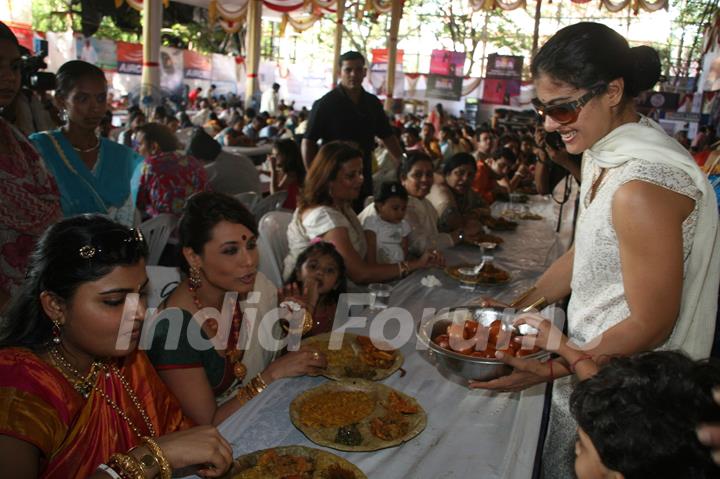 Kajol serves food to Rani Mukherjee at a Durga Pooja pandal in Mumbai