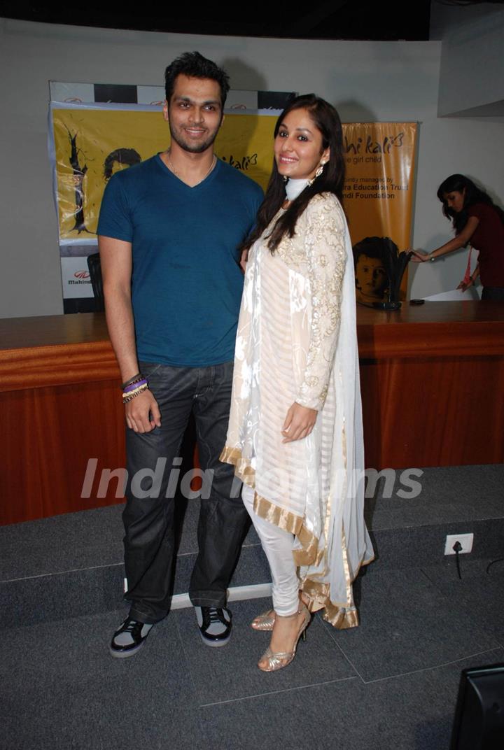 Designer Swapnil Shinde with Femina Miss India Pooja Chopra pose for the photographers after she presents a cheque of Rs 12 Lacs to Nanhi Kali, a project managed by the KC Mahindra Education Trust and the Naandi Foundation to endorse the cause