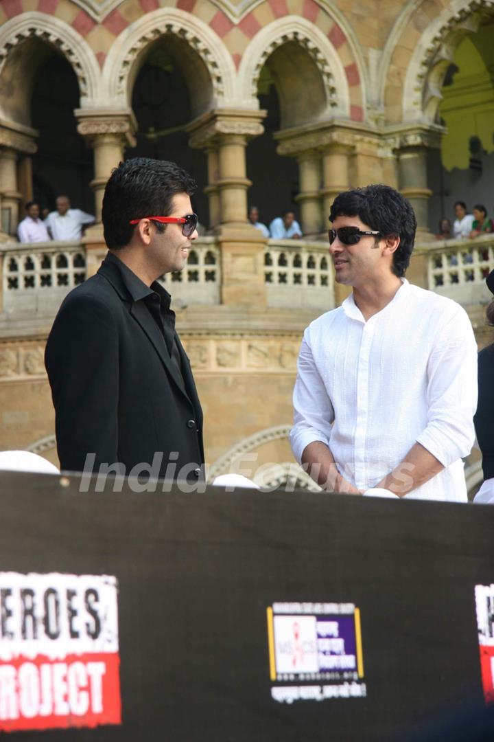 Bollywood actor-director Farhan Akhtar and Karan Johar pose for the photographers during the launch of new communication campaign ''HIV'' and ''Soul Cages''