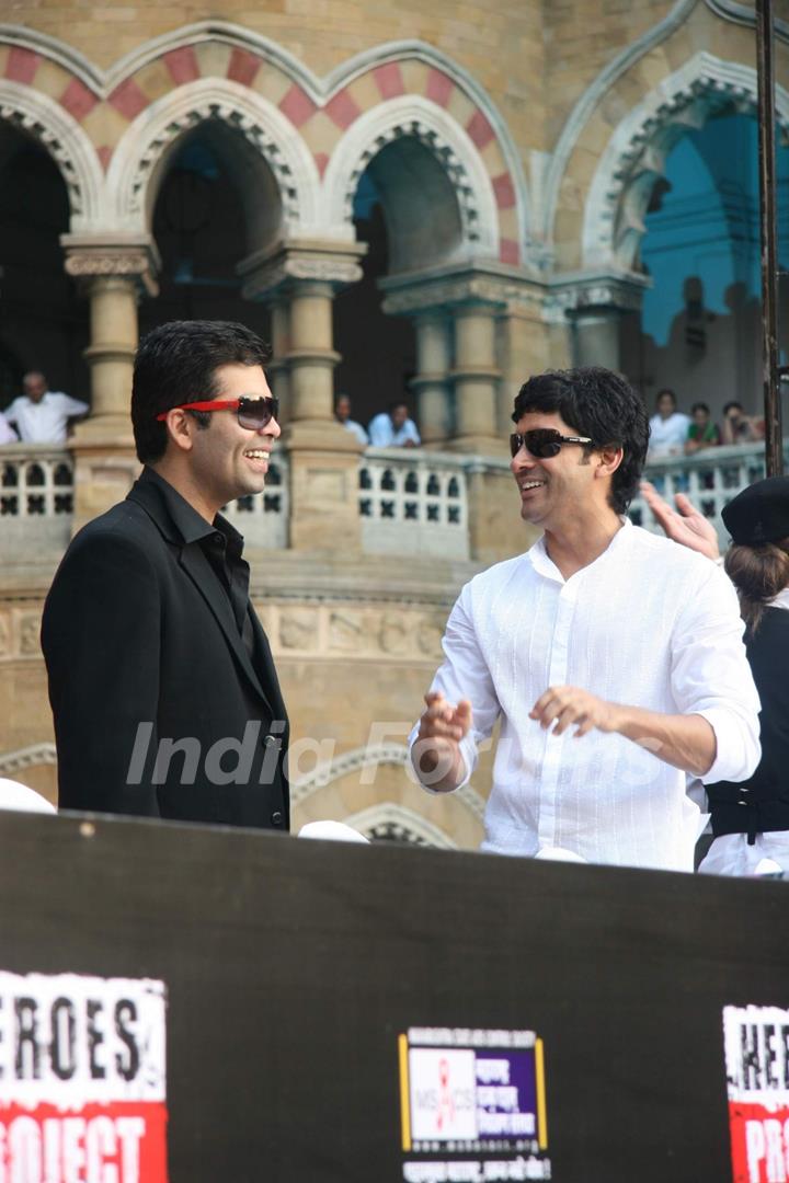 Bollywood actor-director Farhan Akhtar and Karan Johar pose for the photographers during the launch of new communication campaign ''HIV'' and ''Soul Cages''