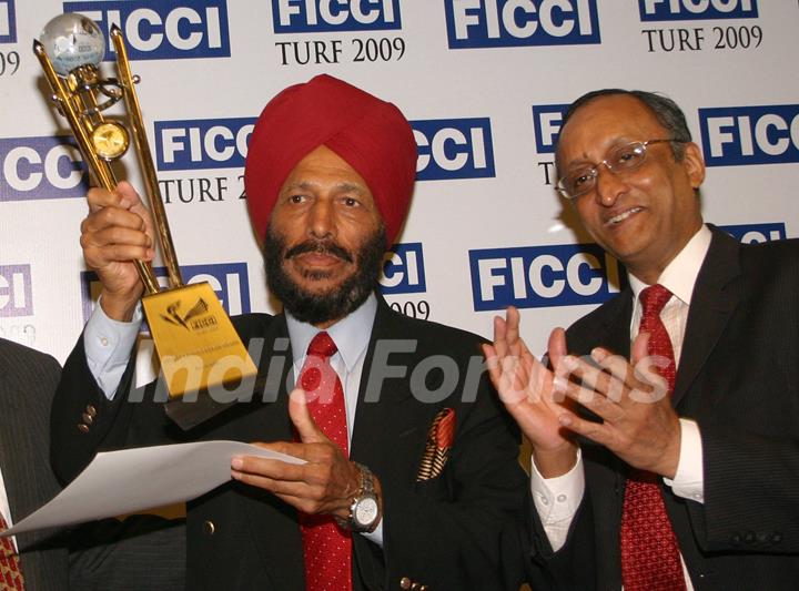 FICCI Sec Gen Dr Amit Mitra presenting sports awards to Milkha Singh in New Delhi on Wednesday 16 Dec 2009