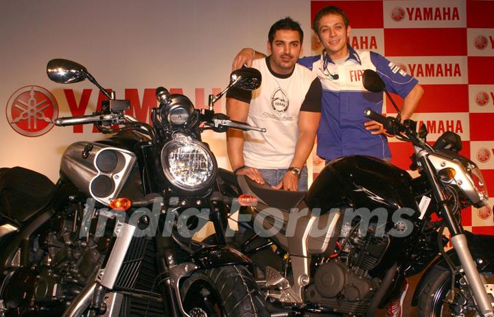 Motogp world champion Valentino Rossi and Bollywood actor John Abraham at a press meet in New Delhi on Sunday